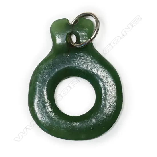 An old (probably pre-European) carved pounamu Māori kākā pōria (parrot leg ring),
